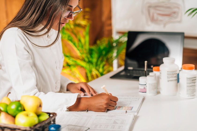Functional medicine doctor in Sydney writing notes.