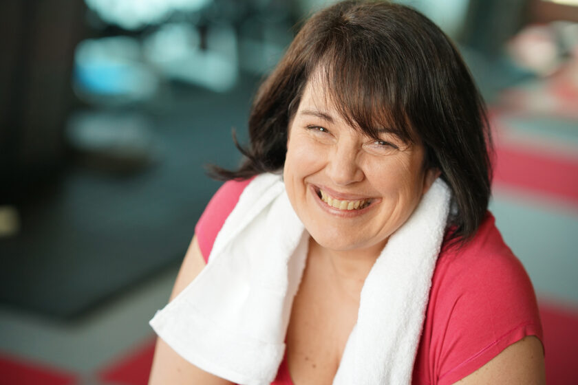 Happy, smiling woman at the gym.